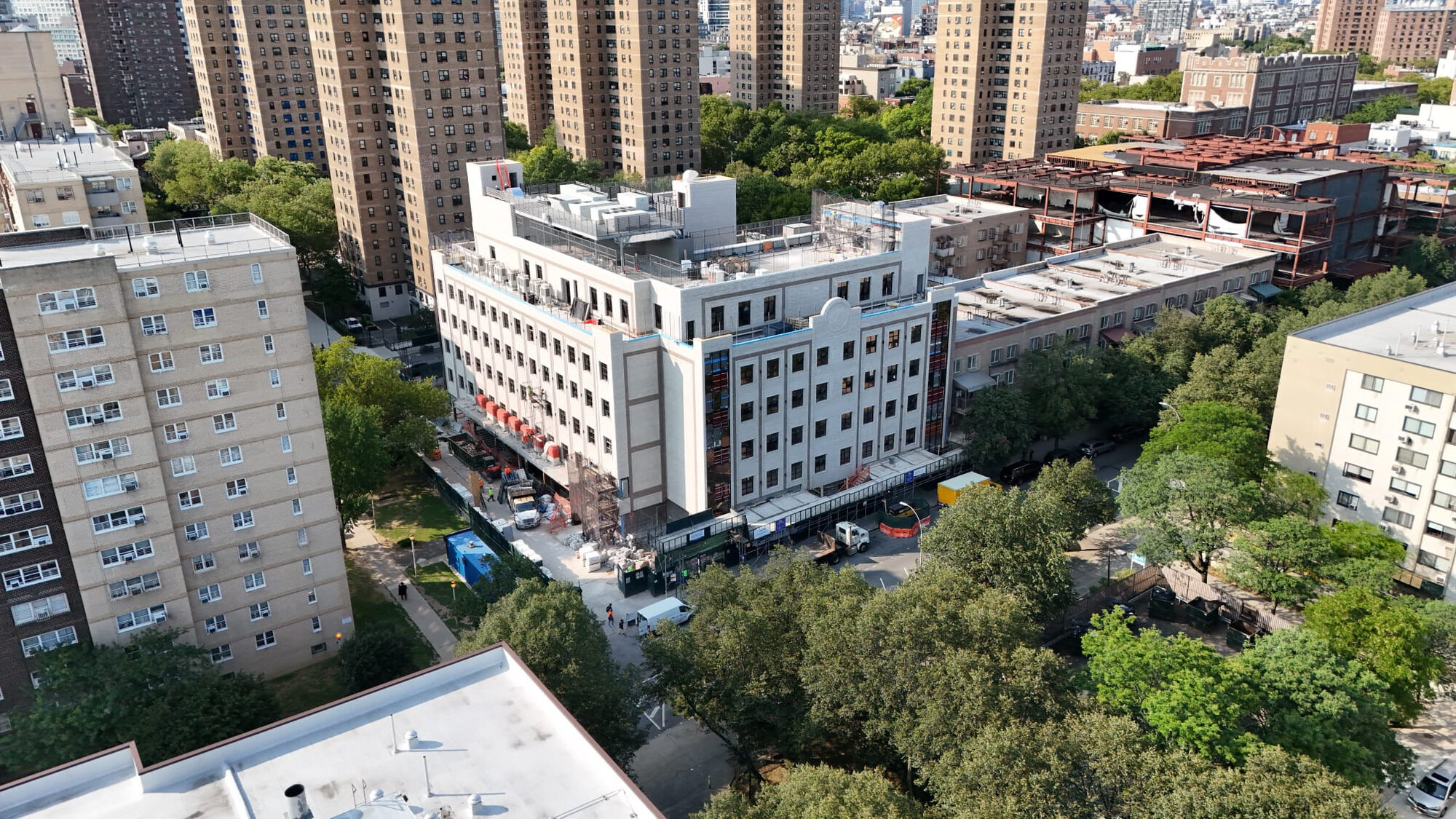 Aerial view of a white masonry mid-rise building under construction
