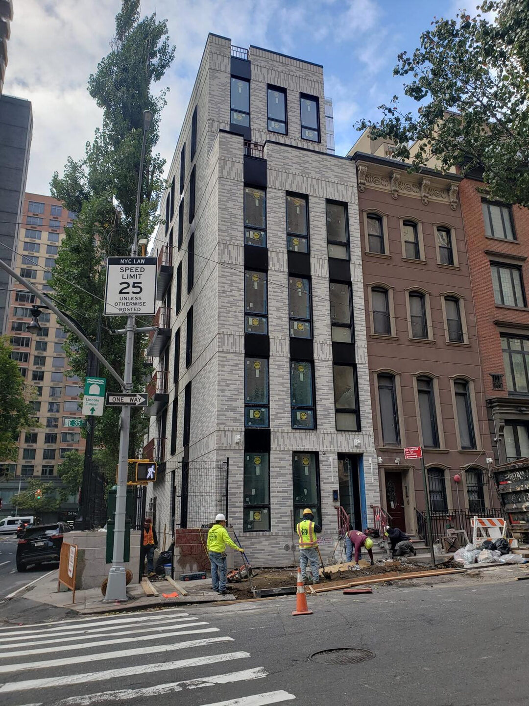 Narrow gray-brick infill townhouse, Brooklyn